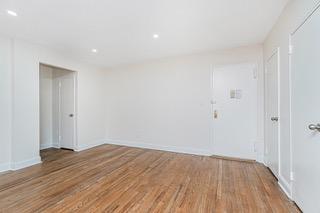 9201 Shore Road, Unit C209 Brooklyn, NY 11209 - Photo 14 of 23 a view of a room with wooden floor and white walls