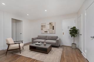 9201 Shore Road, Unit C209 Brooklyn, NY 11209 - Photo 15 of 23 a living room with furniture and a potted plant