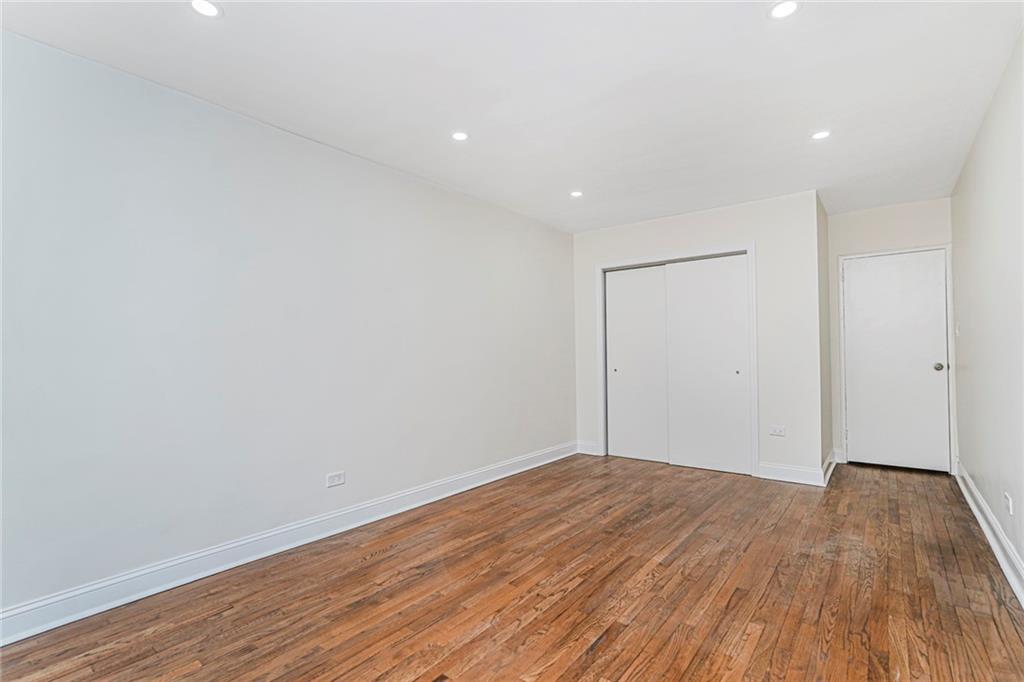 9201 Shore Road, Unit C209 Brooklyn, NY 11209 - Photo 16 of 23 a view of room with wooden floor and white walls