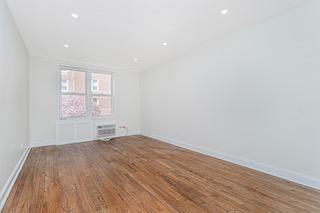 9201 Shore Road, Unit C209 Brooklyn, NY 11209 - Photo 17 of 23 an empty room with wooden floor and windows