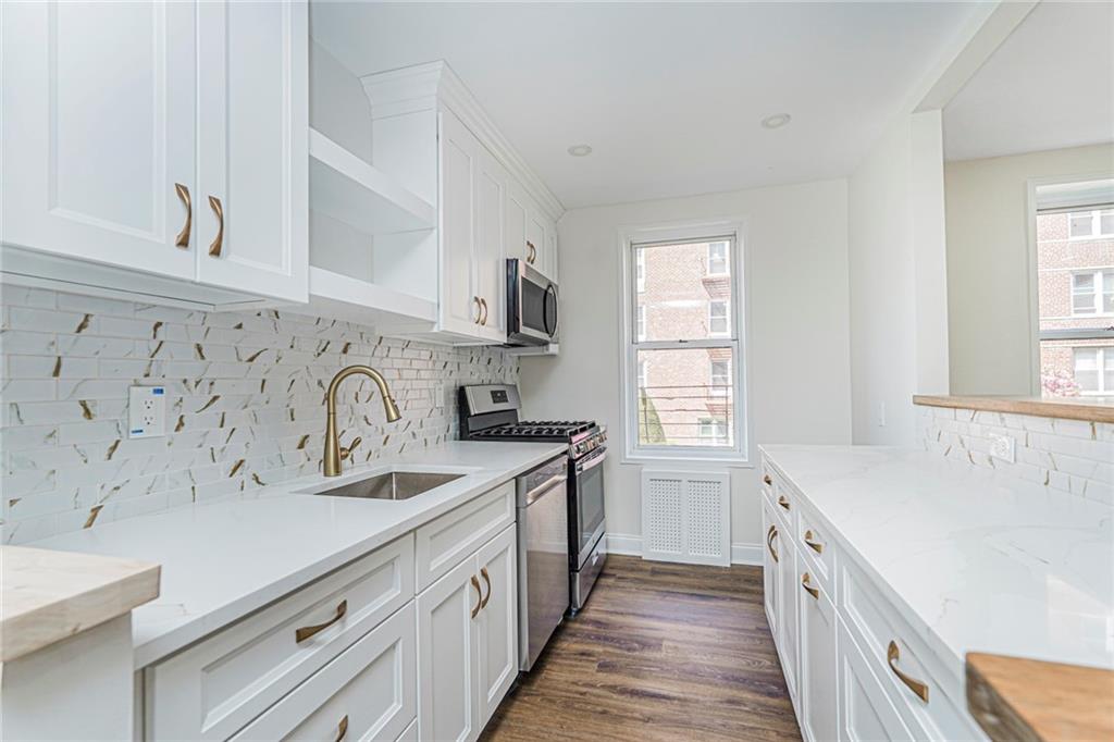 9201 Shore Road, Unit C209 Brooklyn, NY 11209 - Photo 5 of 23 a kitchen with a sink stove and cabinets