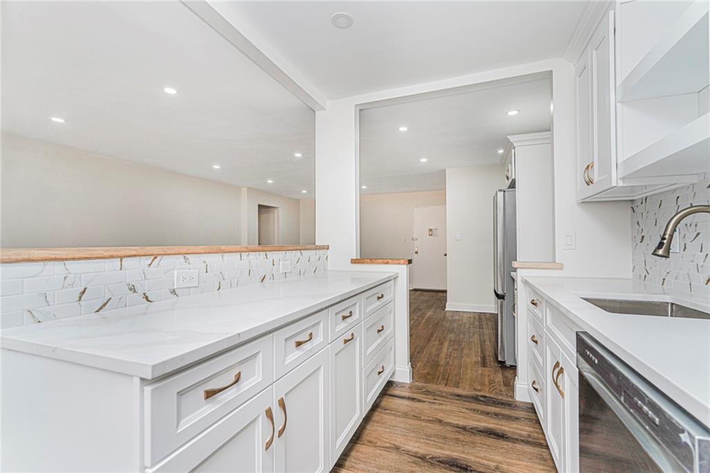 9201 Shore Road, Unit C209 Brooklyn, NY 11209 - Photo 8 of 23 a spacious bathroom with a double vanity sink and a mirror