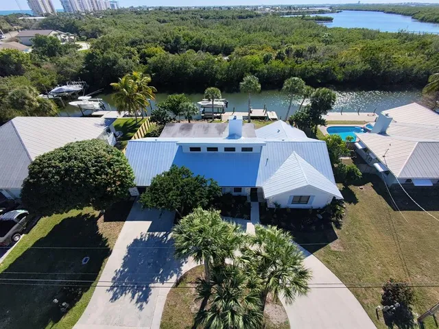 an aerial view of a house with pool patio and outdoor seating