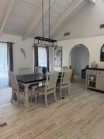 a dining room with furniture and wooden floor