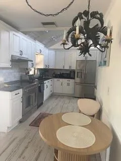 a kitchen with a sink a stove and cabinets