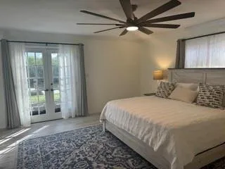 a bedroom with a large bed and a window