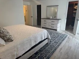 a bedroom with a bed and mirror