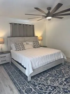 a large bed sitting in a bedroom next to a window