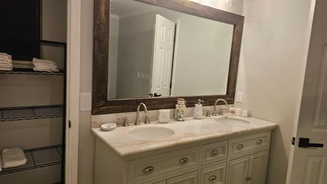 a bathroom with a granite countertop sink and a mirror