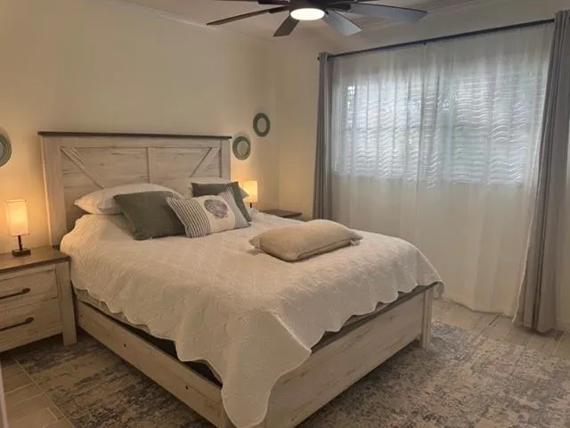 a bedroom with a bed and window