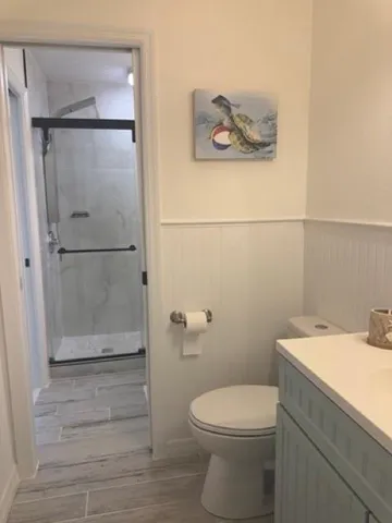 a bathroom with a toilet and a shower