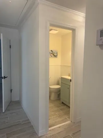 a bathroom with a granite countertop toilet and a sink