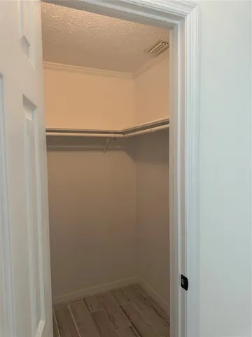 a bedroom with a bed and a mirror