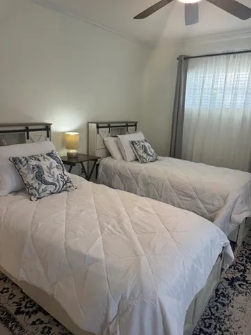 a bedroom with bed and window