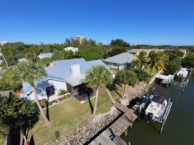 an aerial view of a house with a yard