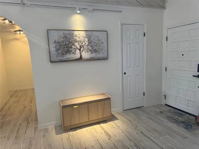 a room with a wooden floor and white walls