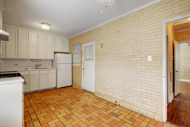 a view of a kitchen with white cabinets