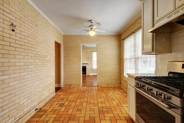 a kitchen with stainless steel appliances a stove a sink and a refrigerator