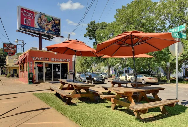 a view of a house with backyard porch and sitting area