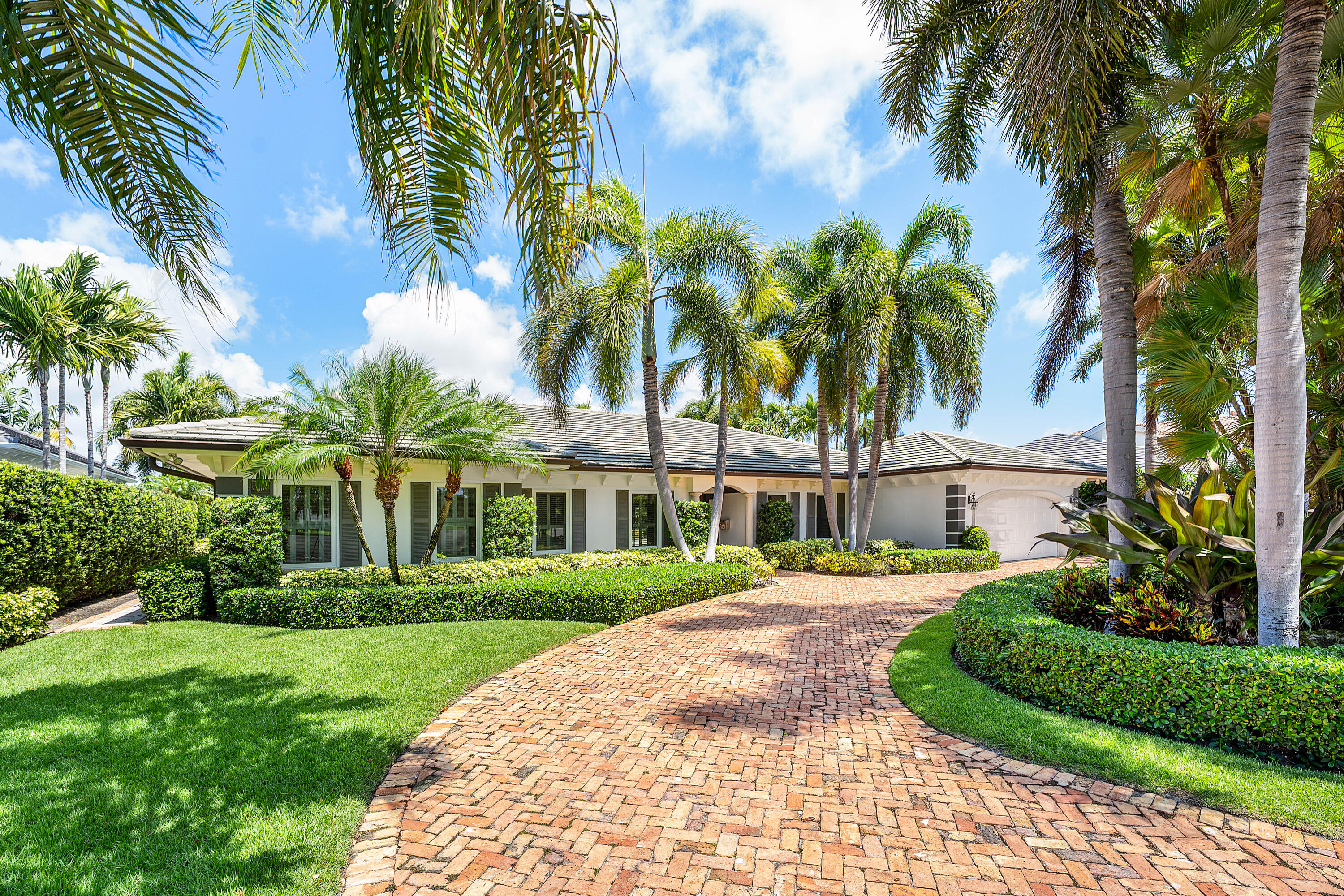 1851 Thatch Palm Drive Boca Raton, FL 33432 - Photo 4 of 70 a front view of a house with a garden