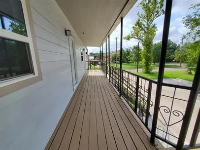 a view of balcony with wooden floor