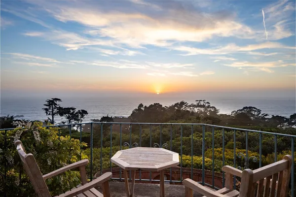 a view of a chair and tables on the roof deck