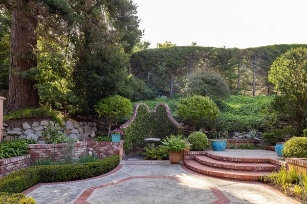 a large bedroom with a bed and wooden floor