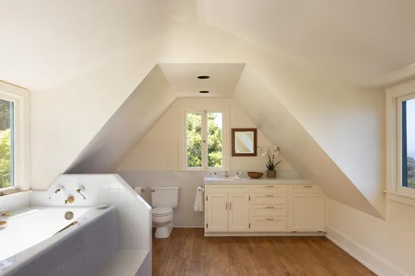 a view of a dining room with furniture large windows and wooden floor