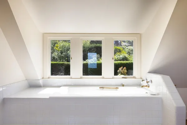a view of a dining room with furniture large windows and wooden floor