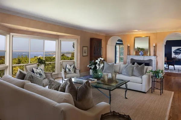 a living room with fireplace furniture and a chandelier