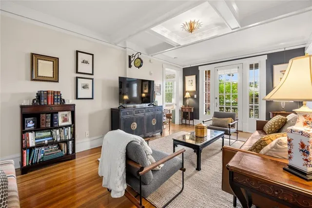a living room with furniture and a flat screen tv with wooden floor