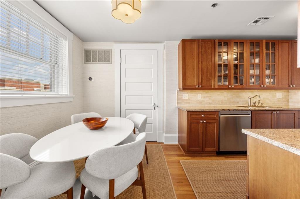266 11th Street Northeast, Unit 203 Atlanta, GA 30309 - Photo 11 of 50 a kitchen with a stove a sink and a refrigerator