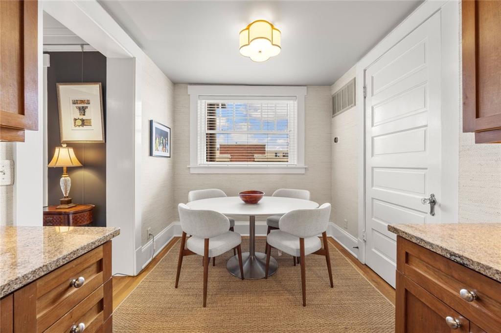 266 11th Street Northeast, Unit 203 Atlanta, GA 30309 - Photo 12 of 50 a view of a dining room with furniture window and wooden floor