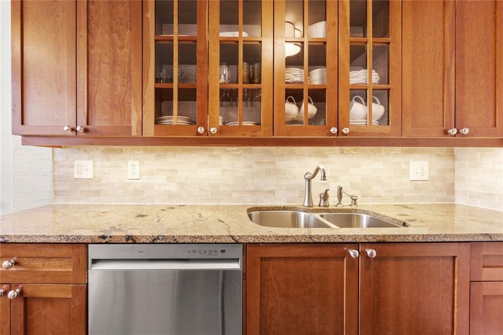 266 11th Street Northeast, Unit 203 Atlanta, GA 30309 - Photo 16 of 50 a kitchen with granite countertop a sink and cabinets