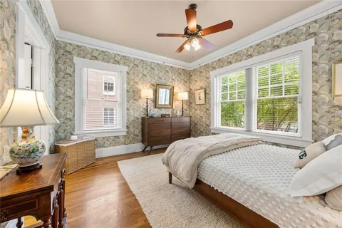 a spacious bedroom with a large bed and a chandelier