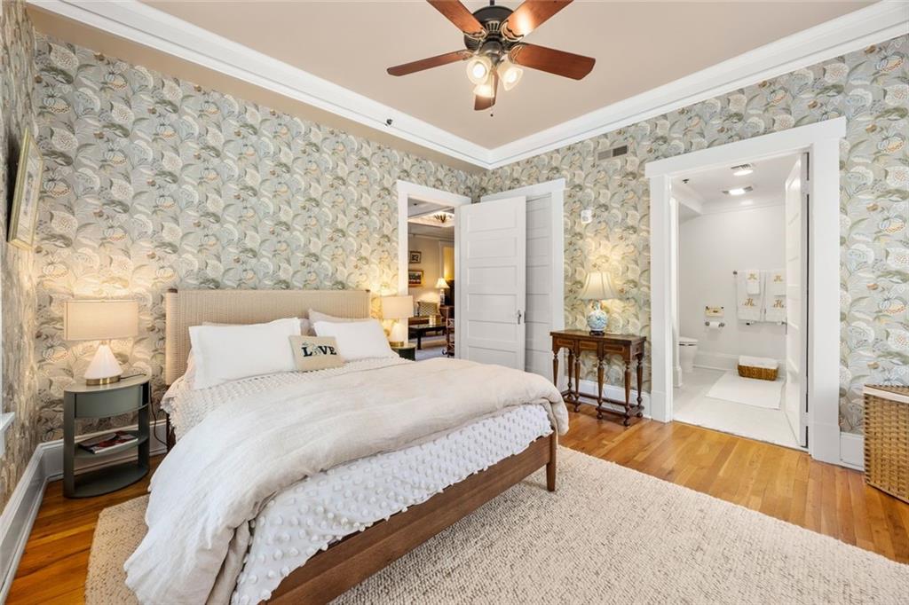 266 11th Street Northeast, Unit 203 Atlanta, GA 30309 - Photo 19 of 50 a spacious bedroom with a bed and a chandelier