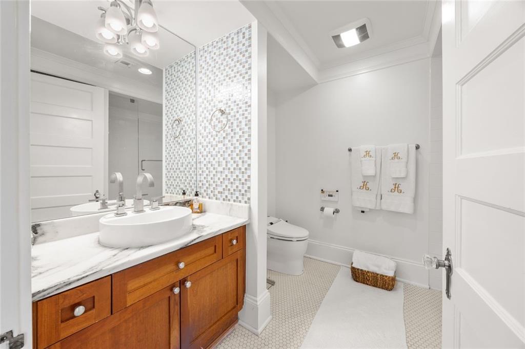 266 11th Street Northeast, Unit 203 Atlanta, GA 30309 - Photo 20 of 50 a bathroom with a double vanity sink mirror and toilet