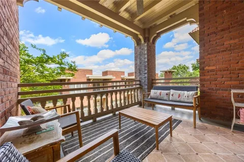 a view of a balcony with wooden benches