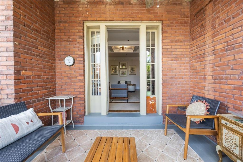 266 11th Street Northeast, Unit 203 Atlanta, GA 30309 - Photo 28 of 50 a view of a door with a chairs and table and couch