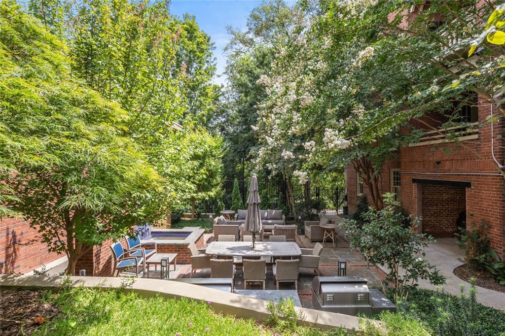 266 11th Street Northeast, Unit 203 Atlanta, GA 30309 - Photo 41 of 50 a view of a patio with table and chairs potted plants and large tree