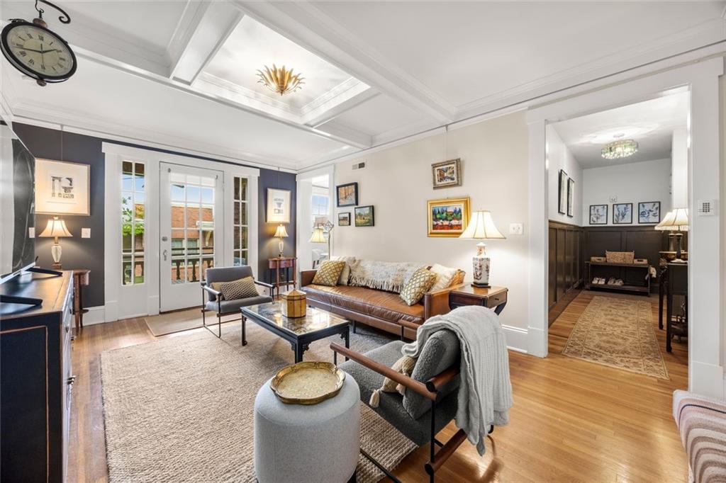 266 11th Street Northeast, Unit 203 Atlanta, GA 30309 - Photo 5 of 50 a living room with furniture and a wooden floor