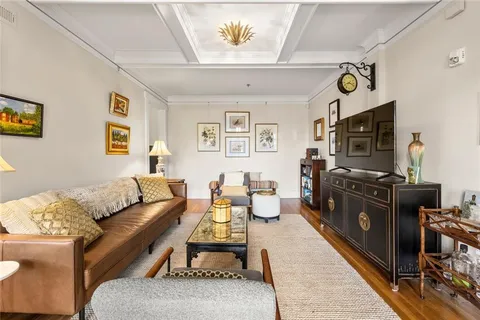 a living room with furniture flat screen tv and a couch