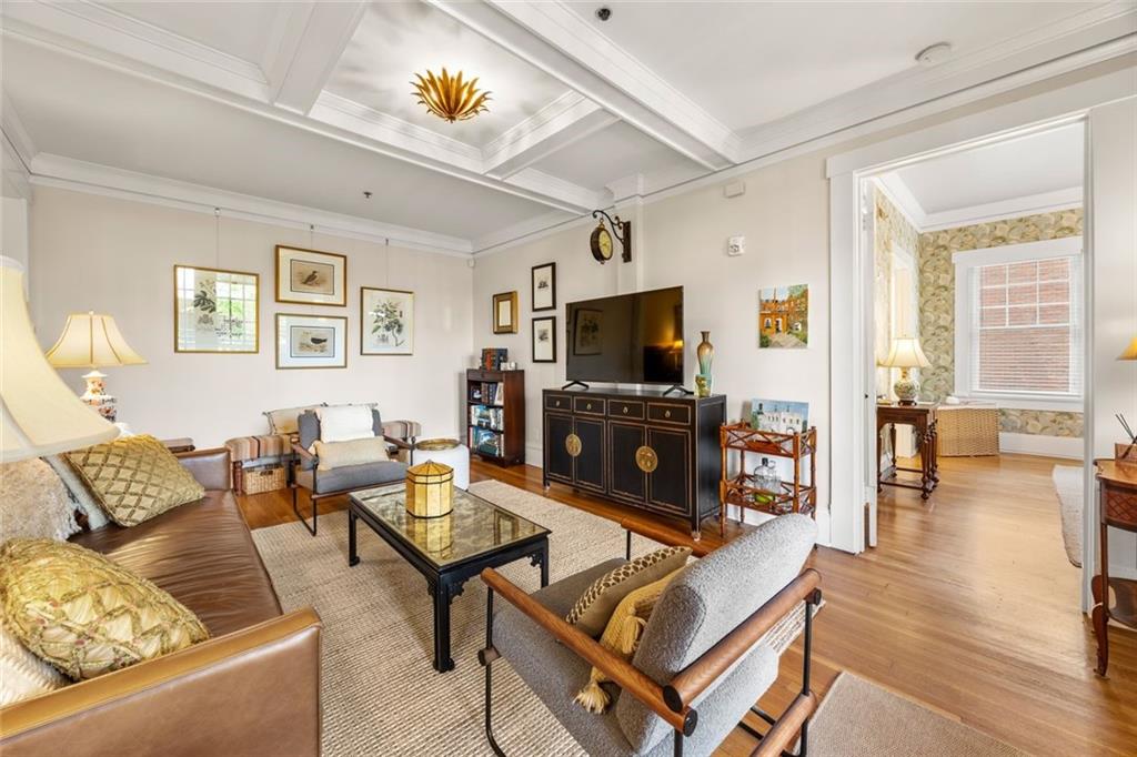 266 11th Street Northeast, Unit 203 Atlanta, GA 30309 - Photo 9 of 50 a living room with furniture a fireplace and a flat screen tv