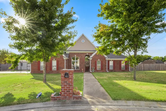 a front view of house with yard and green space