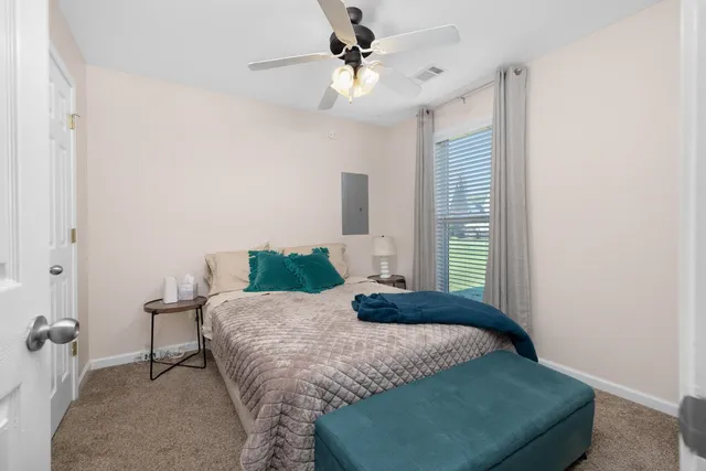 a bedroom with a bed and window