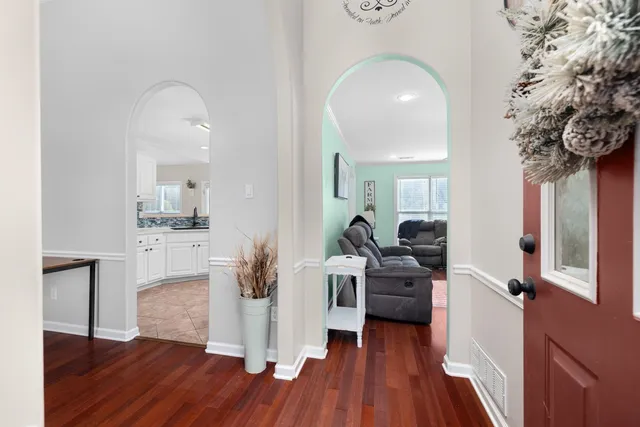 a view of living room with furniture and wooden floor