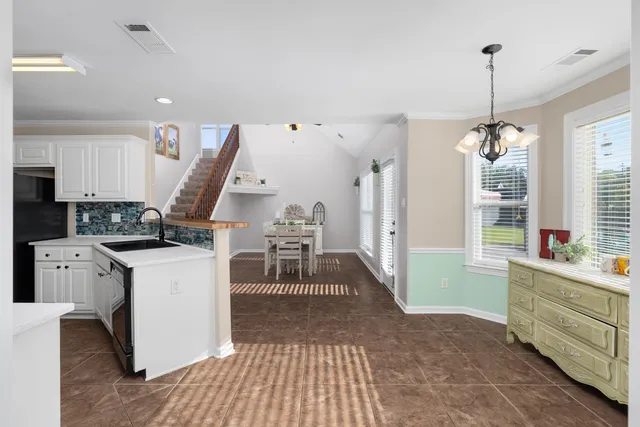 a view of a kitchen with furniture and wooden floor