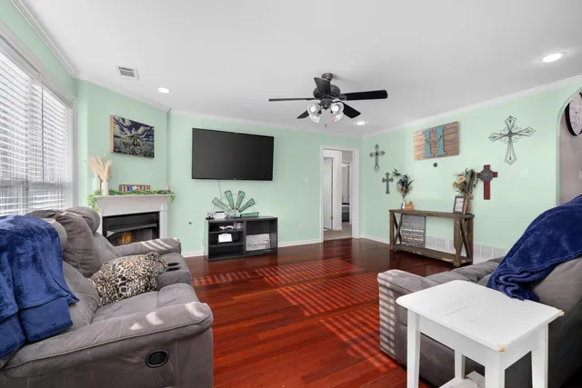 a living room with furniture a fireplace and a flat screen tv