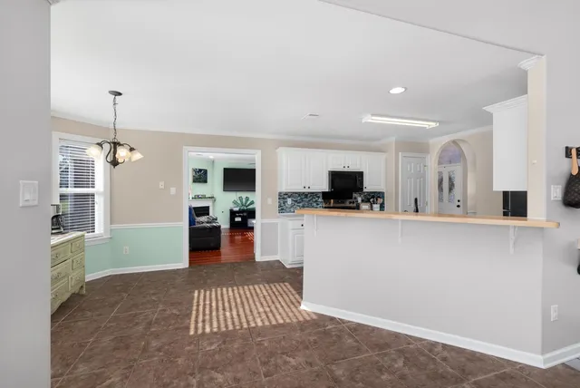a living room with furniture and kitchen view