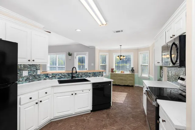a kitchen with a sink stove and refrigerator